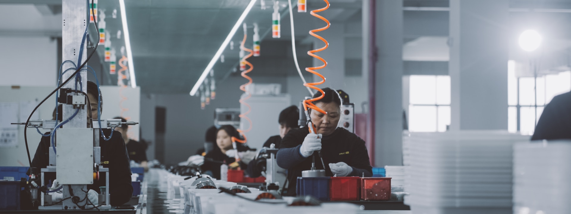 Chinese factory workers on production line — quality control
